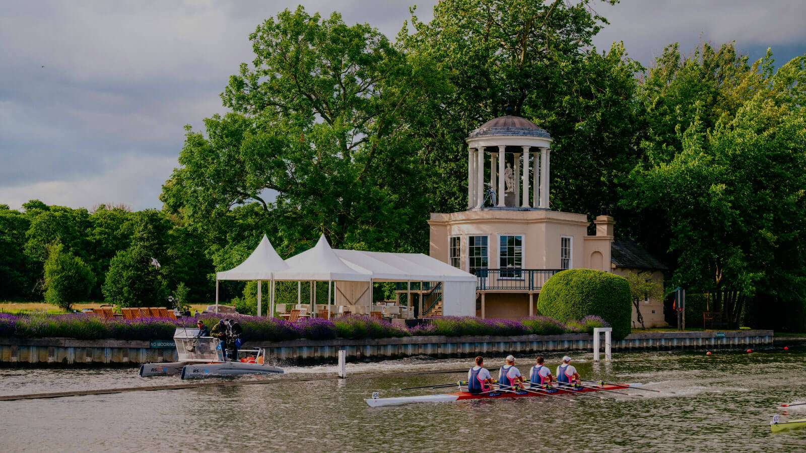 temple island from across the thames river, Green trees and blue sky behind the building