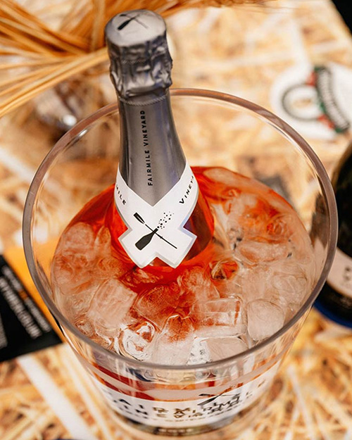A BOTTLE OF RPSE SPARKLING WINE IN AN ICE BUCKET ON A TABLE