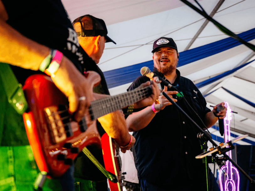 Performer singing on stage at a Luke Combs tribute UK show at The Barn Bar in Henley.