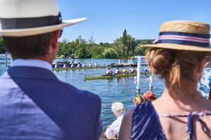 people watching Henley Regatta on a bright sunny day